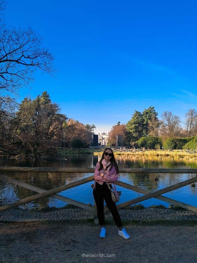 Girl standing next to lake at Sempione park in Milan