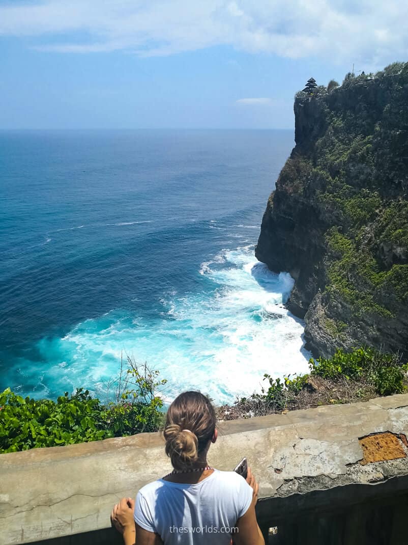Girl looking at ocean from a cliff in Bali
