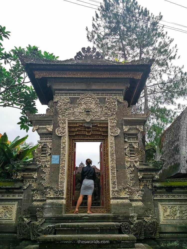 Girl standing at entrance of temple in Ubud