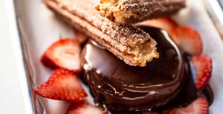 Churros with chocolate and strawberries