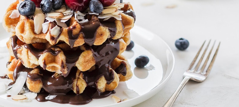 Waffles covered with chocolate and berries